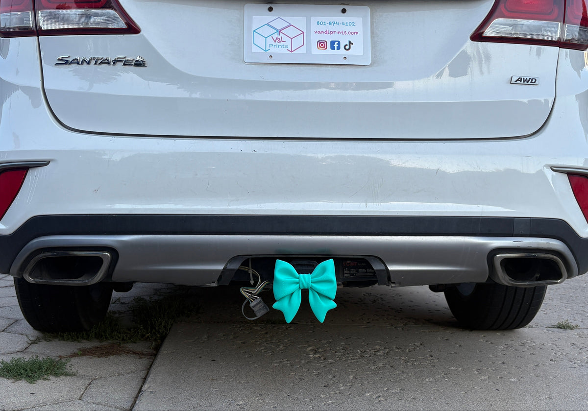 A Mint Green Bow Hitch Insert on a vehicle. 