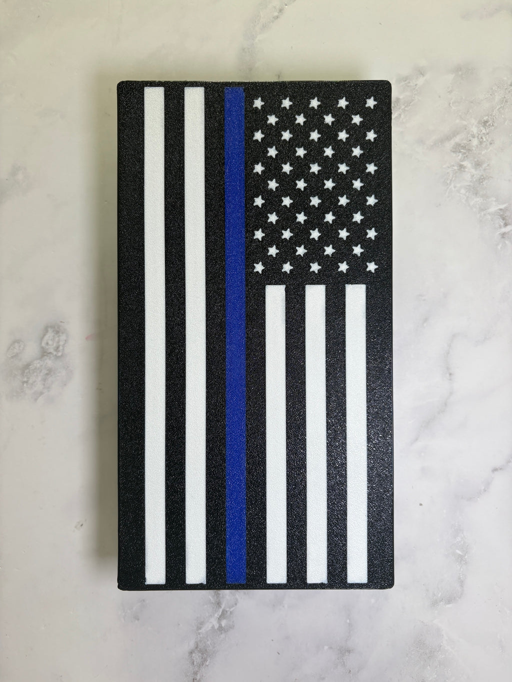 Thin Blue Line flag hitch cover, black and white American flag with a blue stripe, 3D printed, on marble