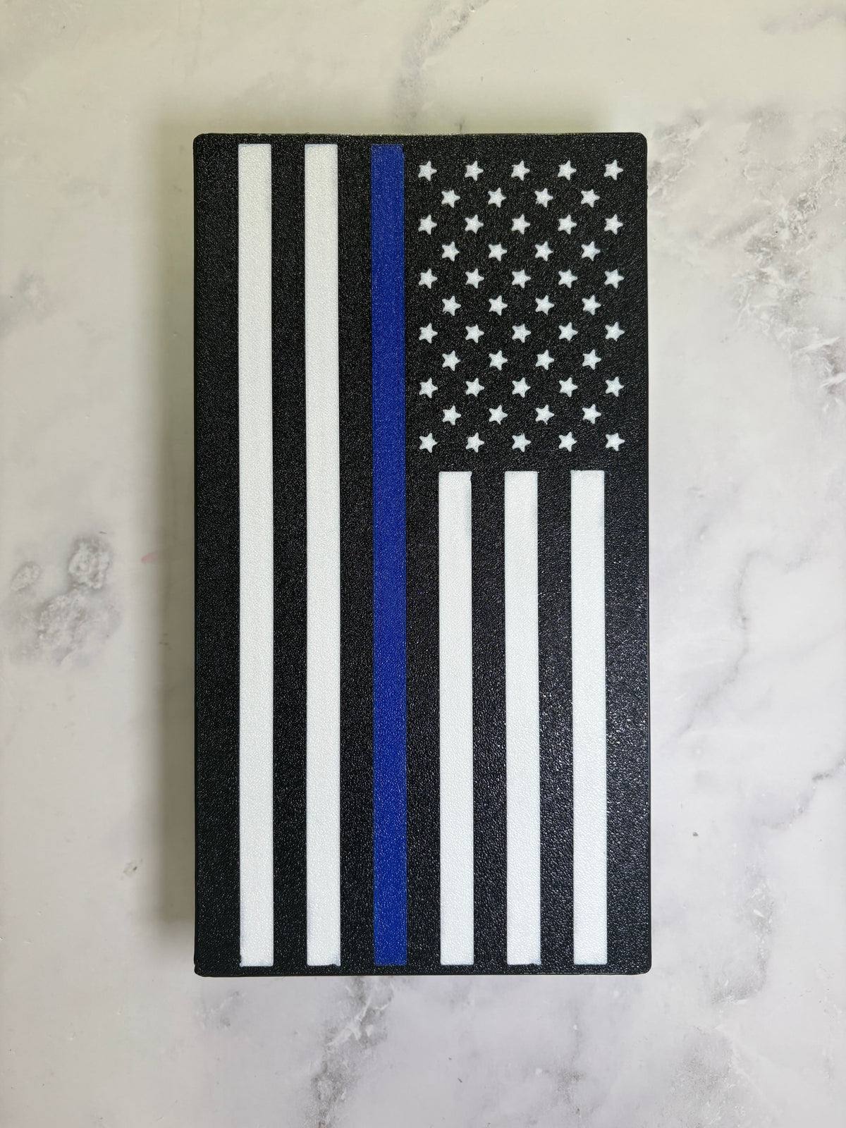 Thin Blue Line flag hitch cover, black and white American flag with a blue stripe, 3D printed, on marble