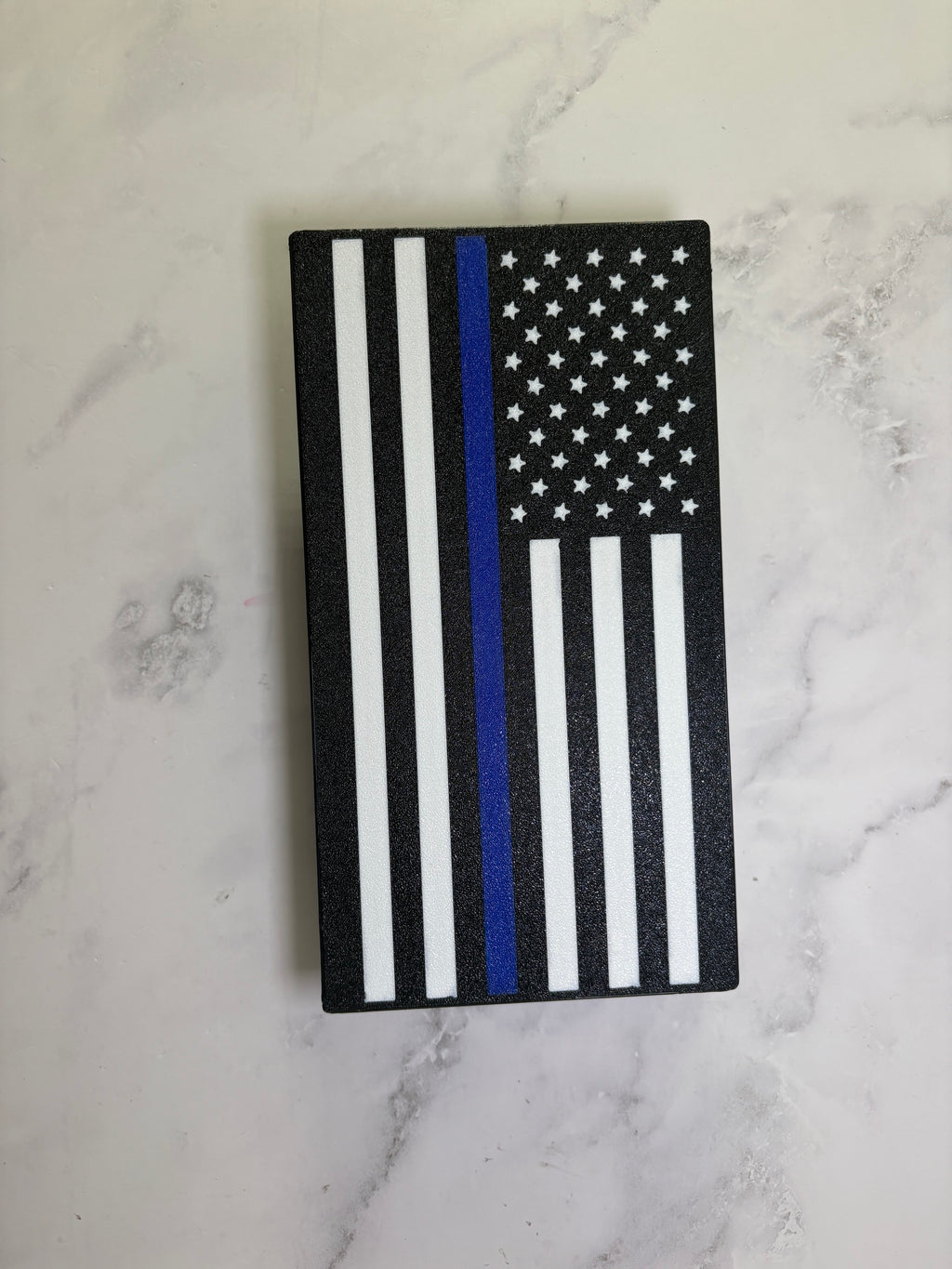 Thin Blue Line flag hitch cover angled view on a marble surface